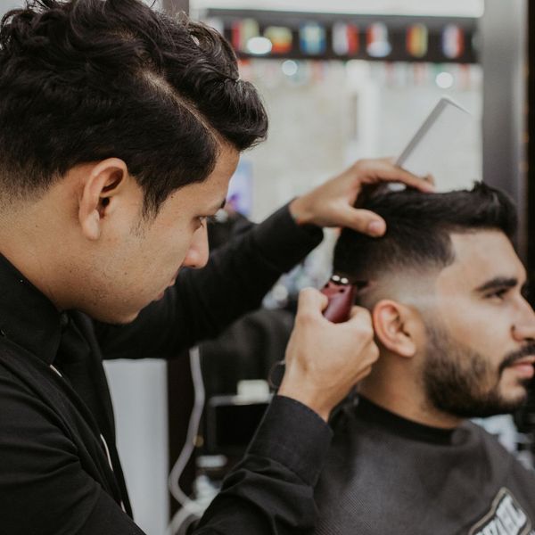 barber cutting man's hair