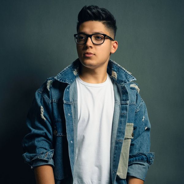 well groomed young man wearing jean jacket