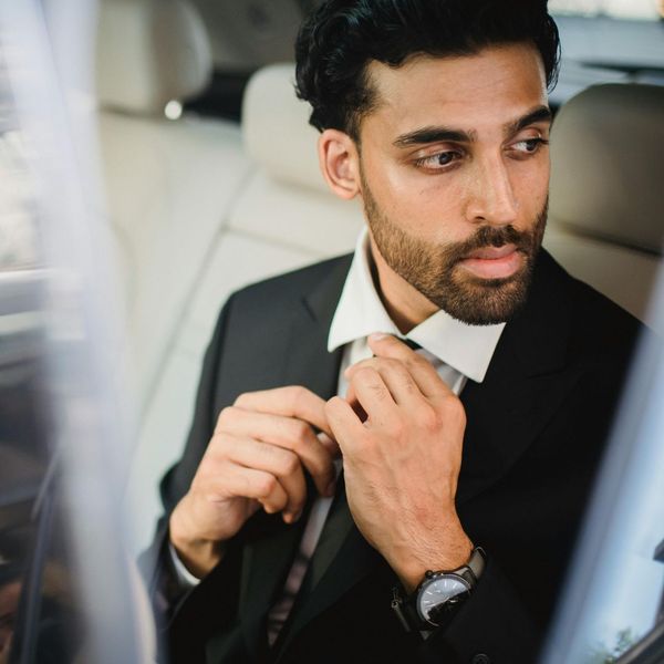 well groomed man wearing suit in a car